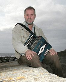 Jackie Daly sitting on rocks